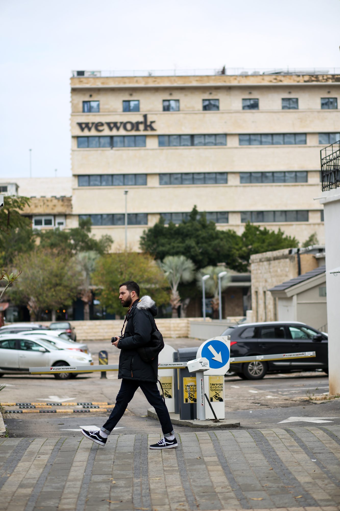 Photo of a man walking in front of the WeWork building