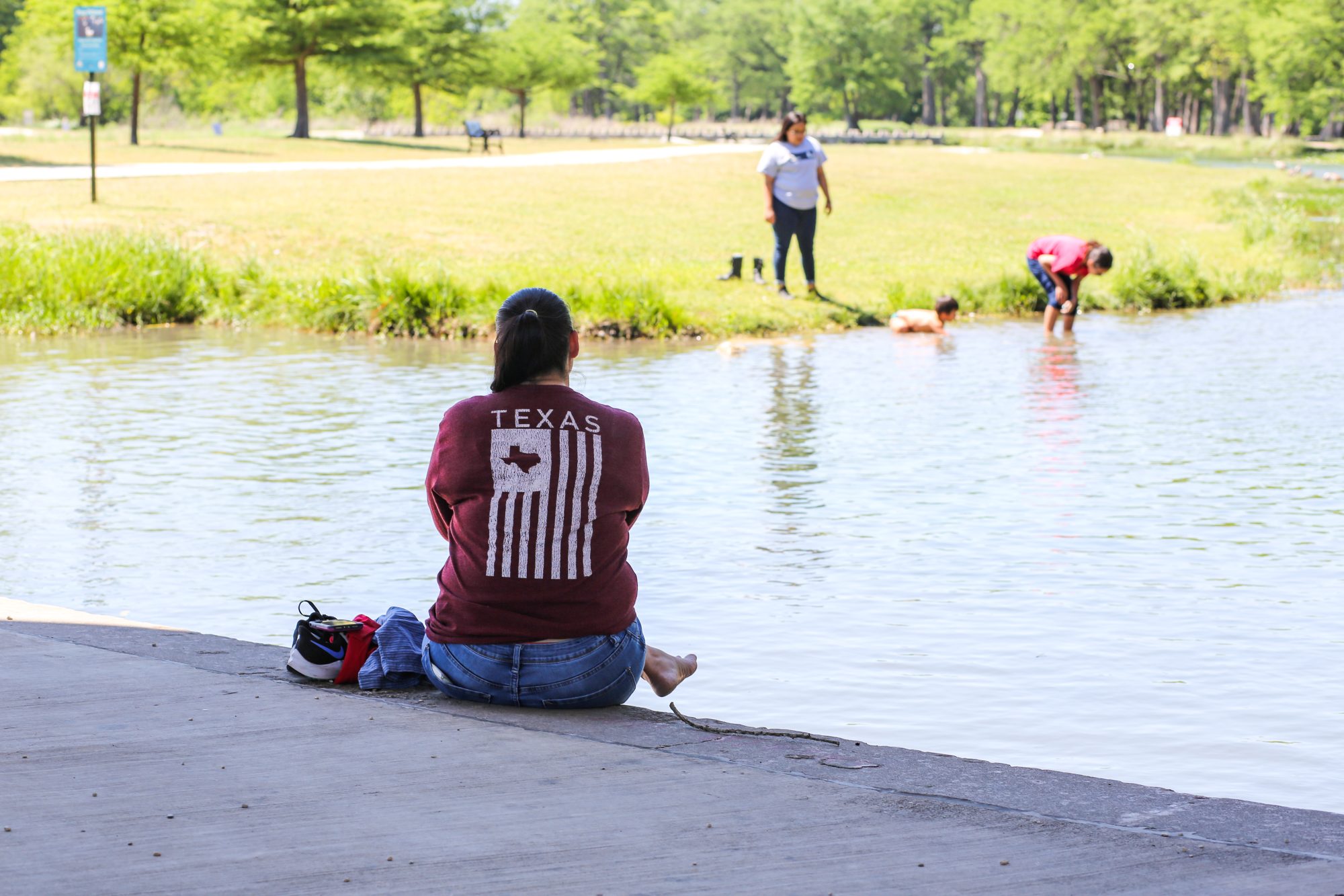 Photo of a person sitting near water