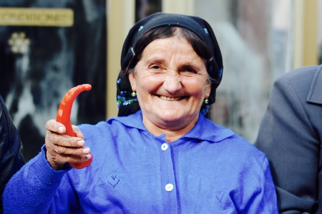 Photo of an Albanian woman holding a pepper