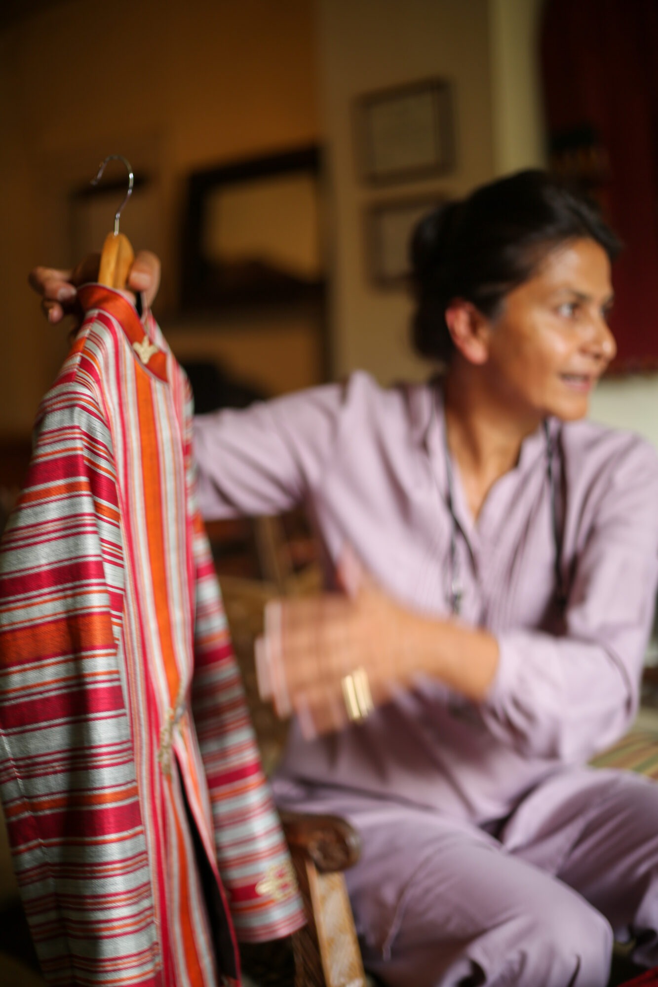 Photo of Afghani designer holding up a garment