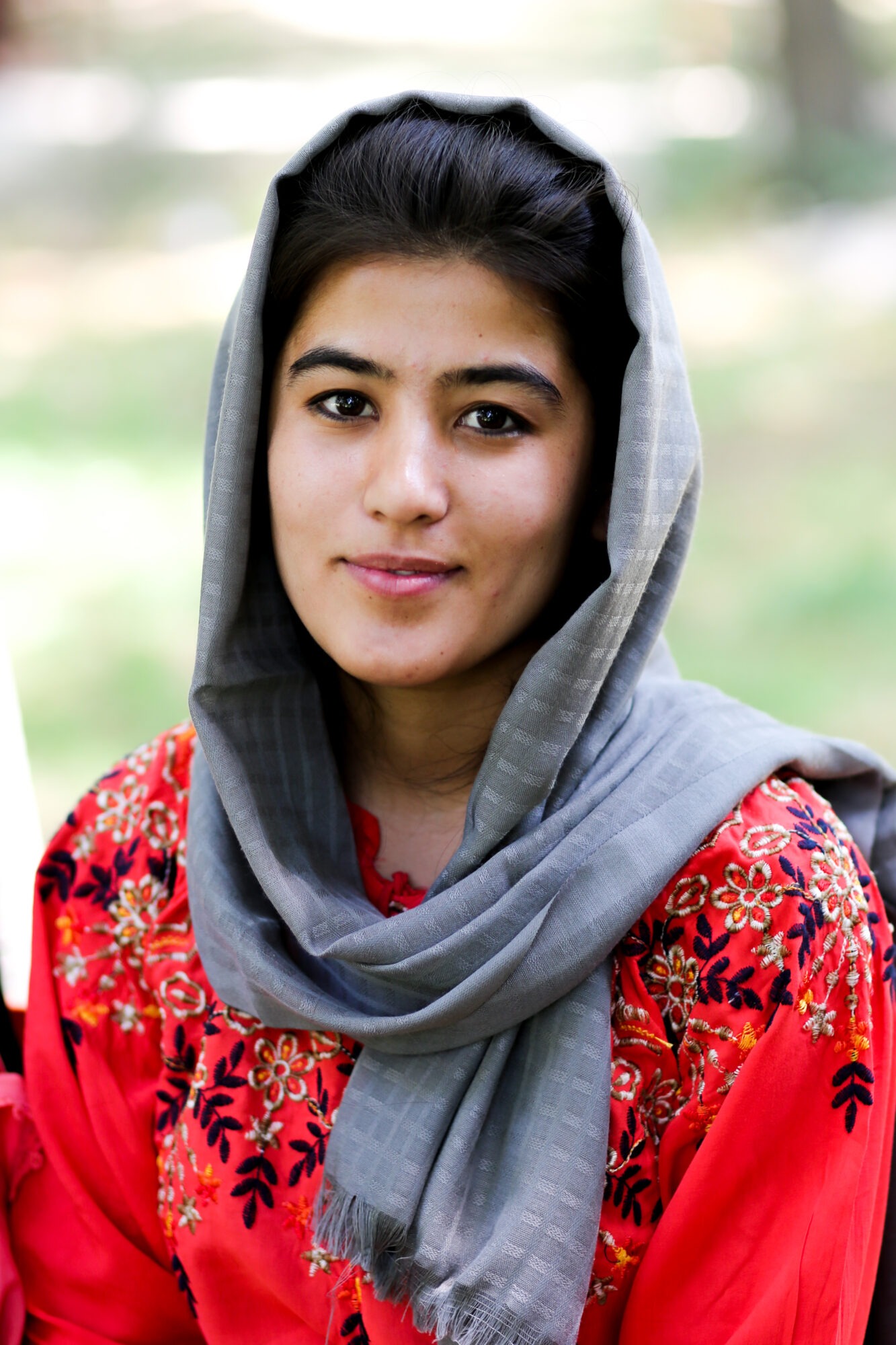 Photo of an Afghani woman in a red blouse
