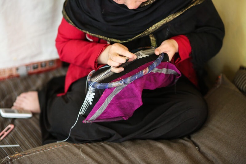 Photo of an Afghani woman stitching
