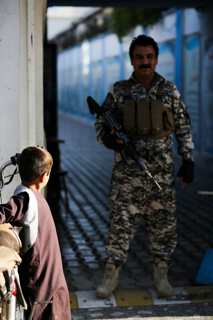 Photo of a guard and a child in Herat