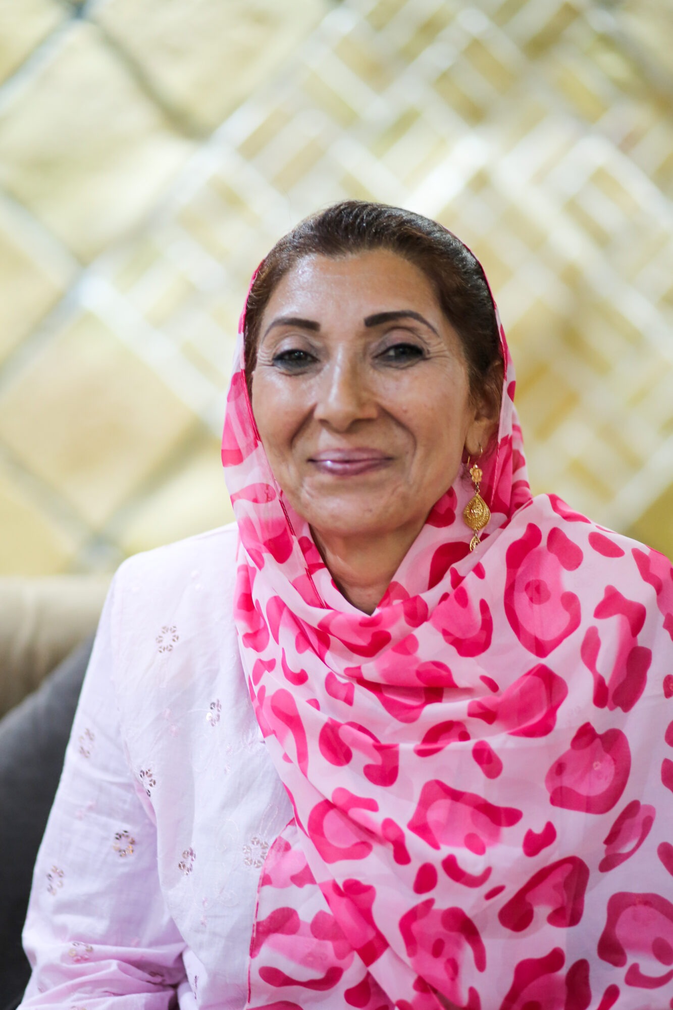 Photo of an Afghani woman in a vibrant pink hijab