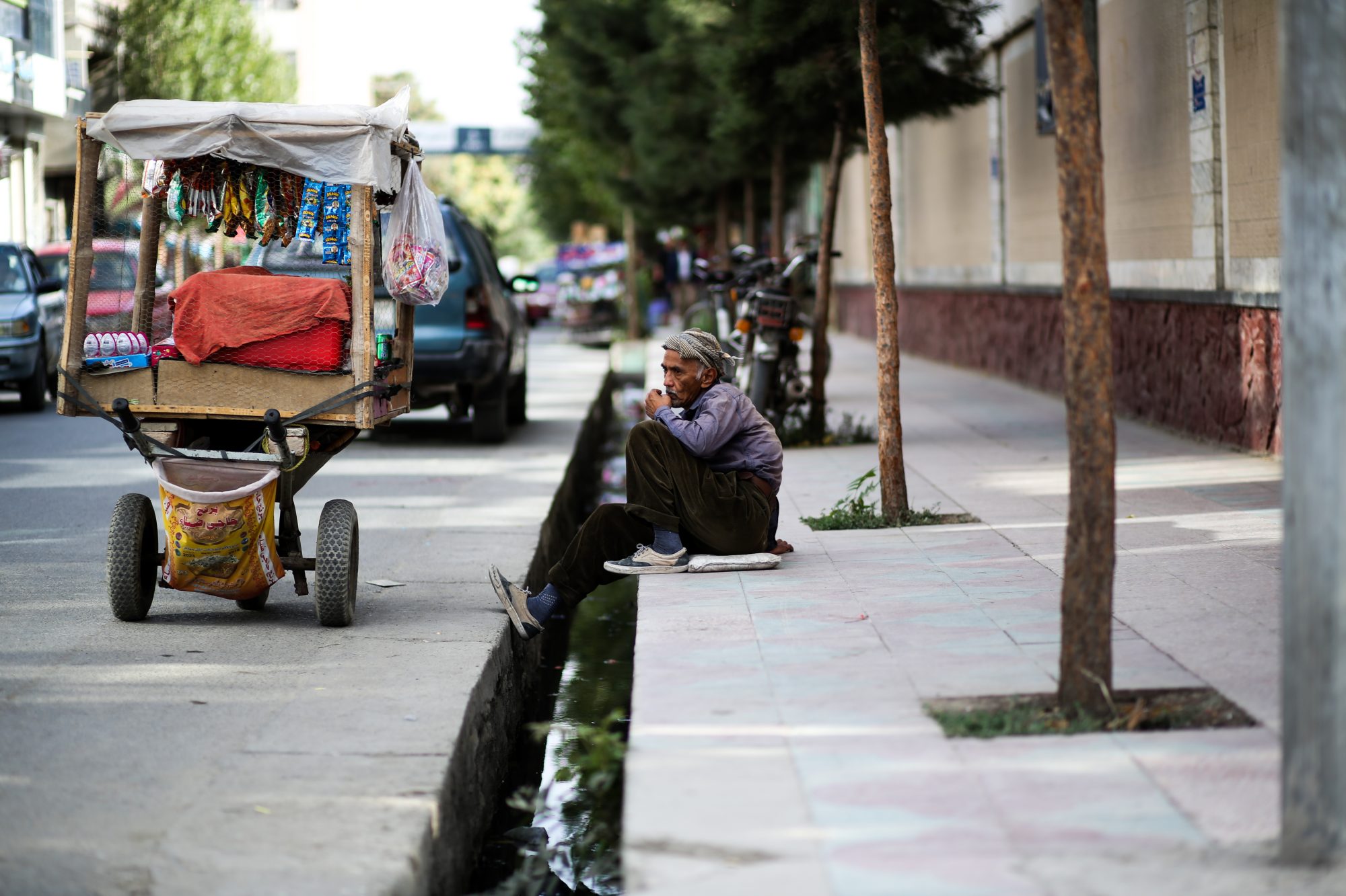 Photo of a person sitting on a curb