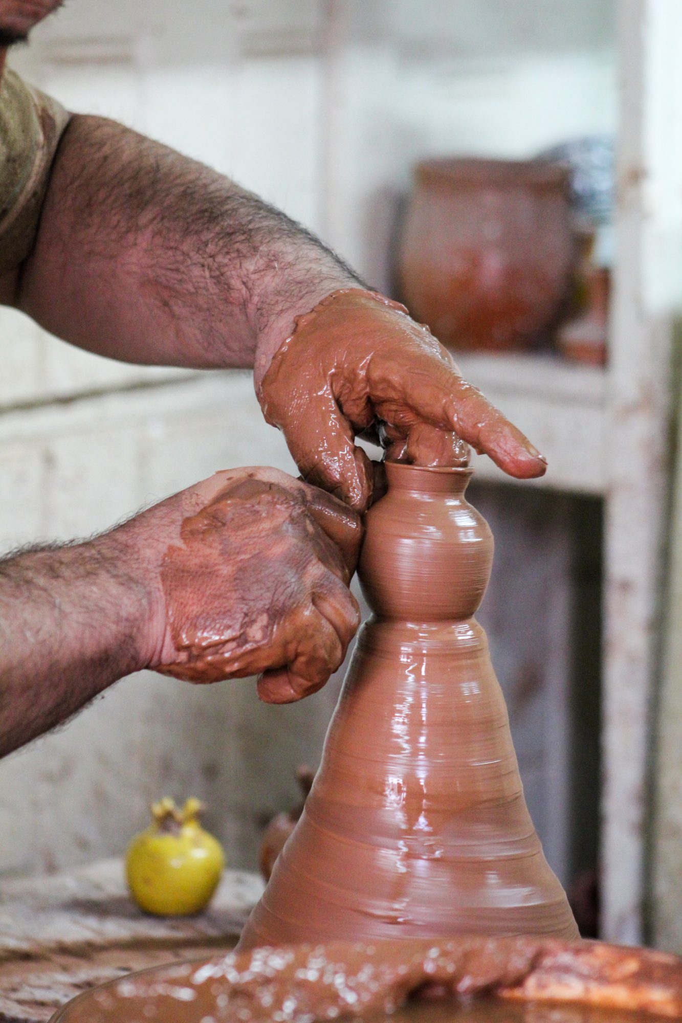 Photo of a person spinning pottery