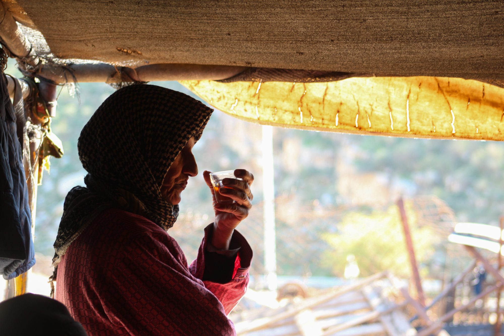 Photo of a person drinking in a tent